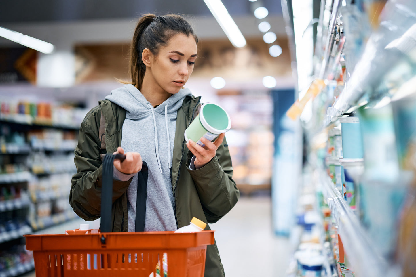 Girl in a grocery store reading nutrition label